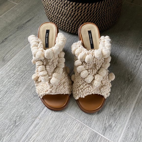 mules with pom poms